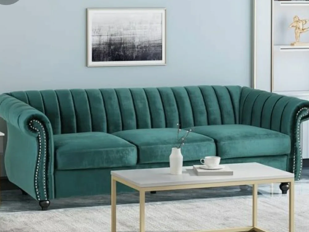 Teal chesterfield sofa with a rolled back and stud detailing.