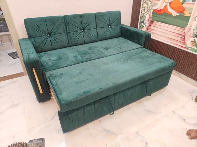 Green sofa-cum-bed with the seat pulled forward.
