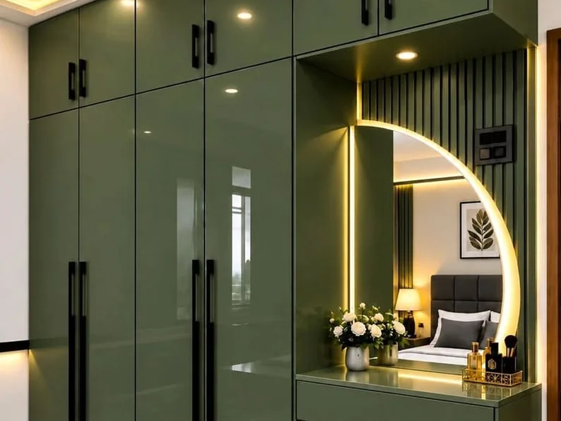 Olive green wardrobe with a backlit mirror and dressing unit.
