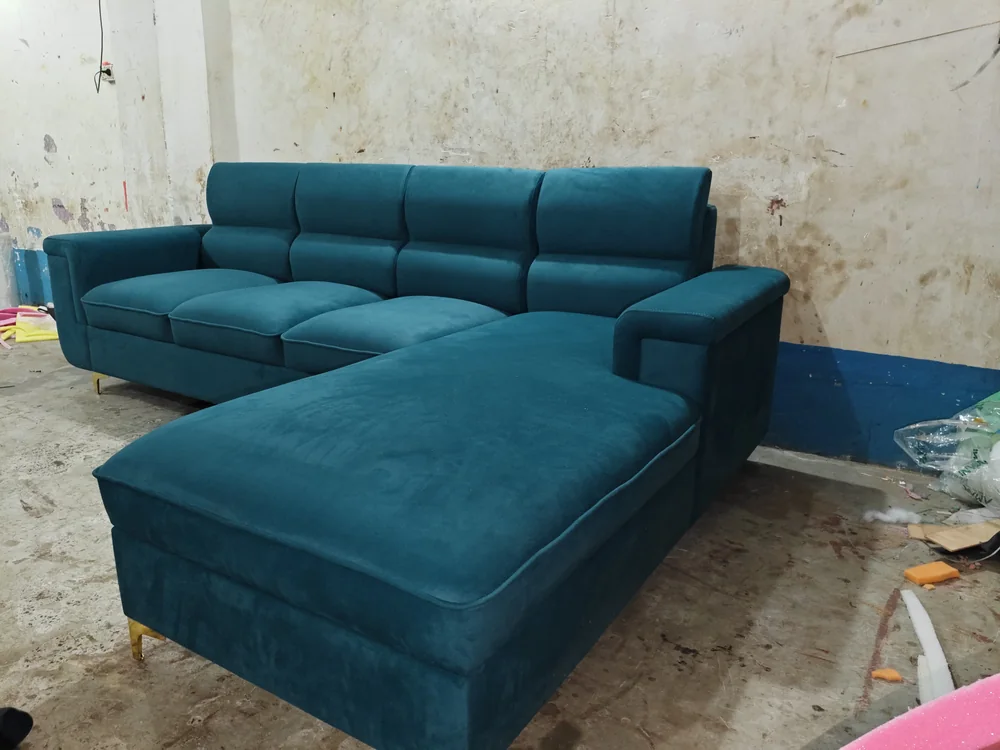 Teal velvet L-shape sofa newly finished on the workshop floor.